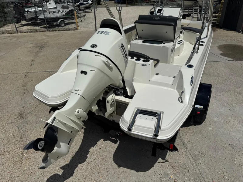 Slide: The Image of 2019 Stingray 186 CC boat with Suzuki outboard motor, parked on concrete. - 12