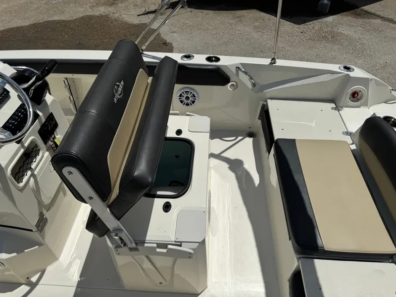 Slide: The Image of 2019 Stingray 186 CC boat interior with seating and steering wheel. - 13
