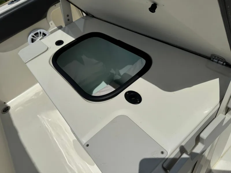 Slide: The Image of 2019 Stingray 186 CC boat interior with storage compartment and speaker. - 14