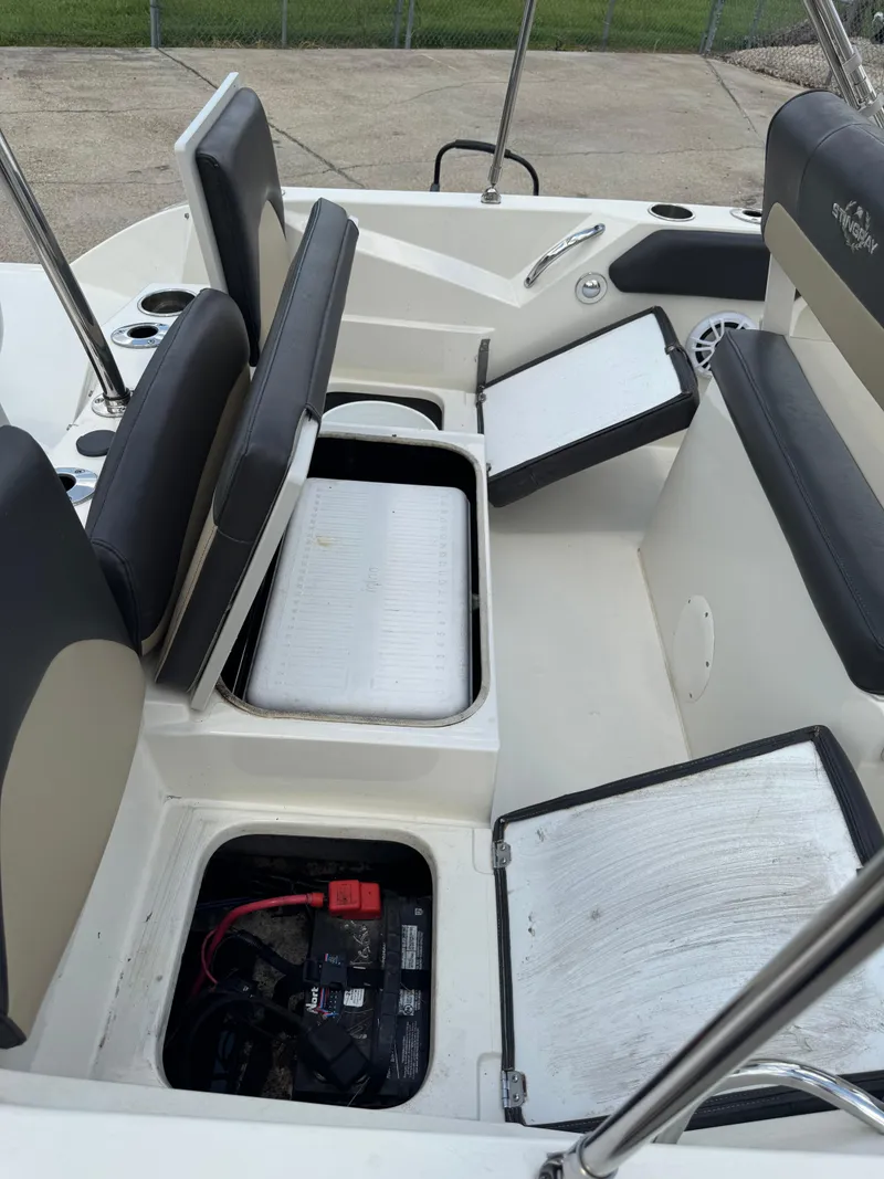 Slide: The Image of 2019 Stingray 186 CC boat interior with open storage compartments and seating. - 16