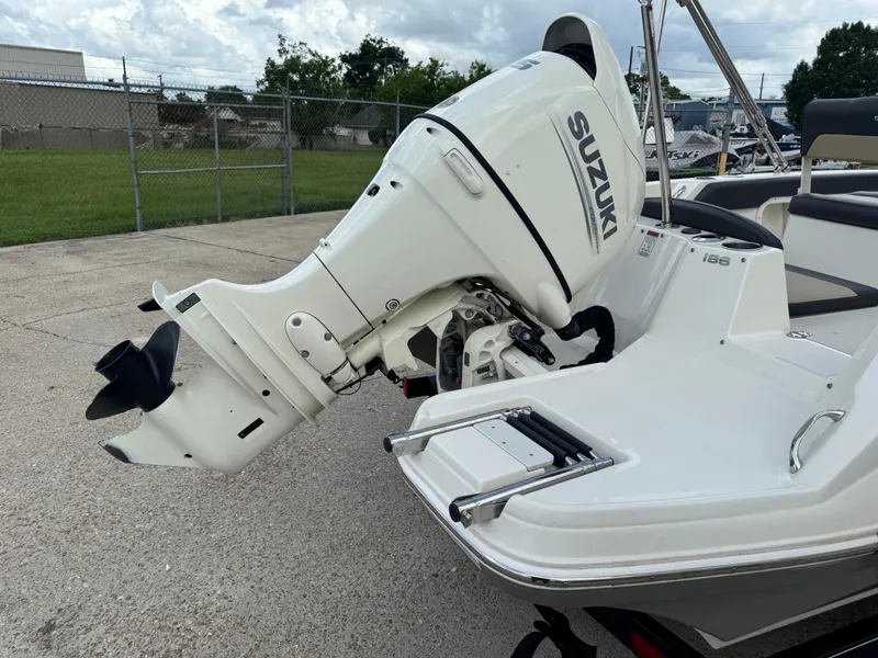 Slide: The Image of 2019 Stingray 186 CC boat with Suzuki outboard motor, parked on concrete. - 21
