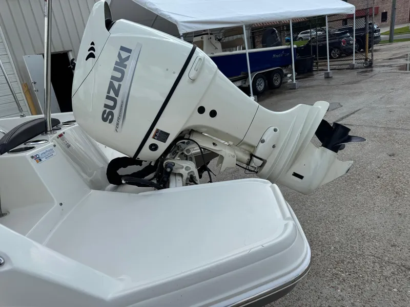 Slide: The Image of 2019 Stingray 186 CC boat with Suzuki outboard motor in a marina setting. - 22