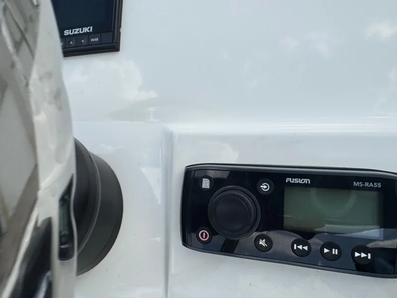 Slide: The Image of 2019 Stingray 186 CC boat dashboard with Suzuki and Fusion MS-RA55 controls. - 26