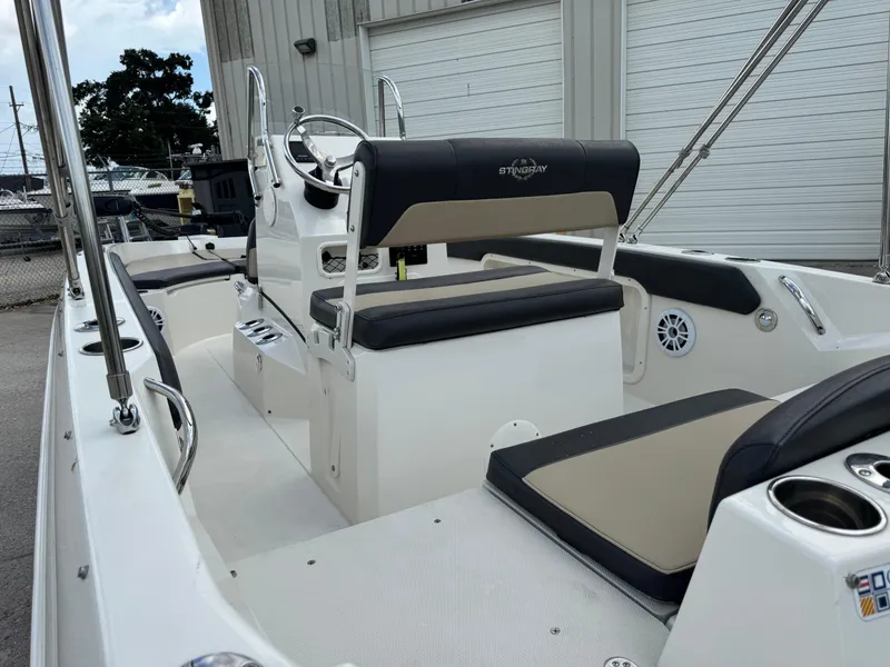 Slide: The Image of 2019 Stingray 186 CC boat interior with seating and steering console. - 29