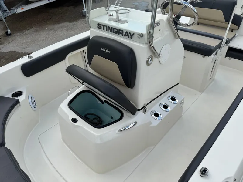 Slide: The Image of 2019 Stingray 186 CC boat interior with seating, storage, and control console. - 30