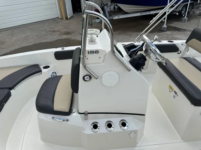Slide: The Image of 2019 Stingray 186 CC boat interior with steering console and seating. - 32