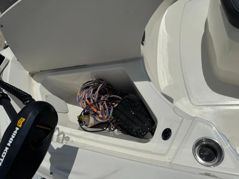 Slide: The Image of 2019 Stingray 186 CC boat storage compartment with rope and equipment. - 35