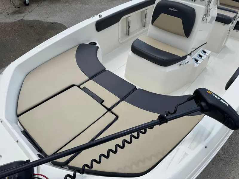 Slide: The Image of 2019 Stingray 186 CC boat interior with cushioned seating and Minn Kota trolling motor. - 37