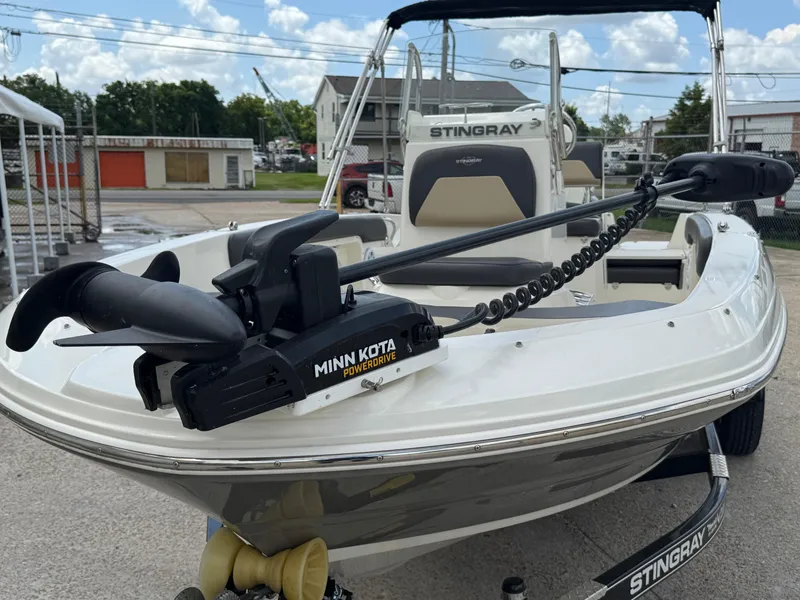 Slide: The Image of 2019 Stingray 186 CC boat with Minn Kota PowerDrive motor, parked outdoors. - 38