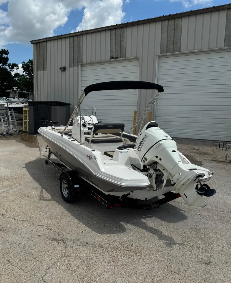 Slide: The Image of 2019 Stingray 186 CC boat with Suzuki outboard motor parked outside a warehouse. - 41