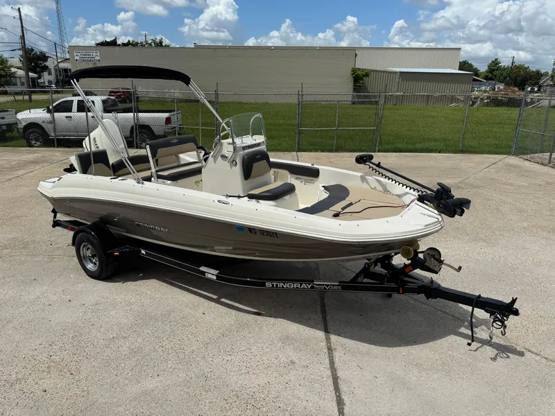 Slide: The Image of 2019 Stingray 186 CC boat on trailer, parked outdoors under a cloudy sky. - 42