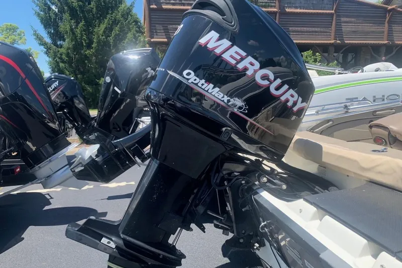 Slide: The Image of Mercury OptiMax outboard motor on a 2008 Ranger 1850VS boat, parked outdoors. - 5