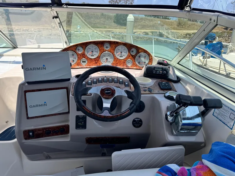 Slide: The Image of 2005 Rinker Fiesta Vee 342 boat dashboard with Garmin navigation systems and control panel. - 7