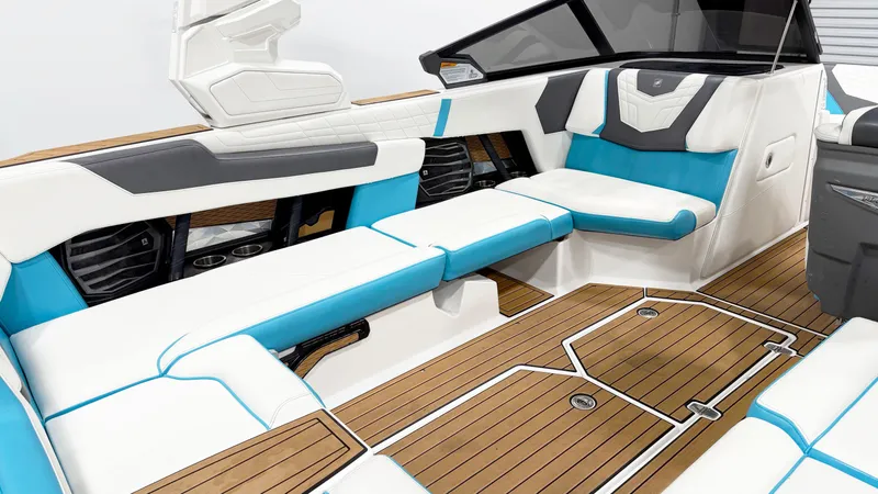 Slide: The Image of 2022 Nautique G23 boat interior with white and blue seating, teak flooring. - 7