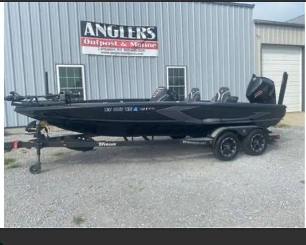 Slide: The Image of 2022 Triton 21 XrT boat at Angler's Outpost & Marine dealership. - 2