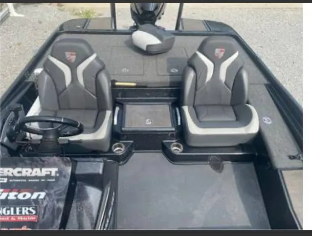 Slide: The Image of 2022 Triton 21 XrT boat interior with dual seats and steering wheel. - 7