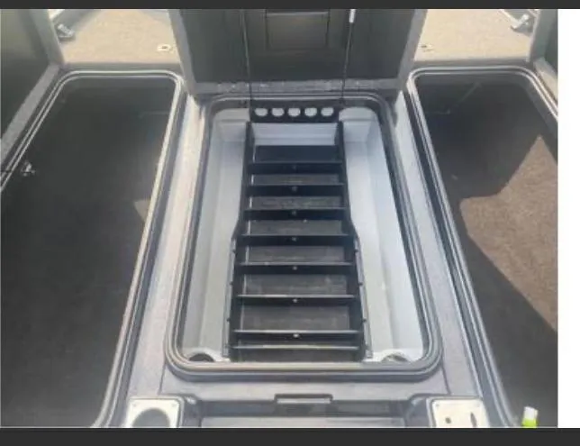 Slide: The Image of 2022 Triton 21 XrT boat storage compartment with organized shelving system. - 8