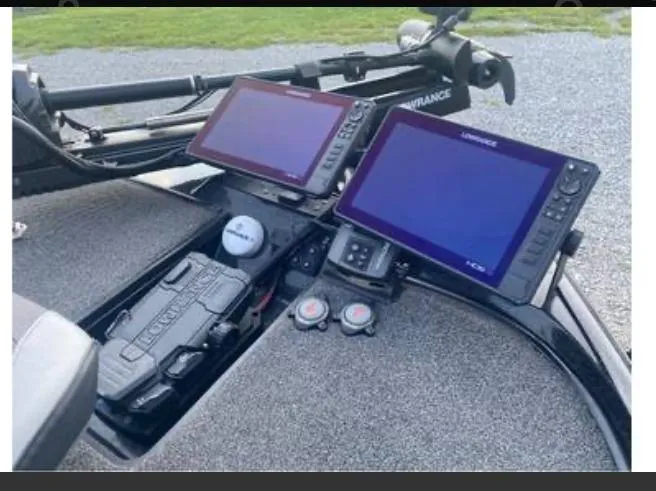 Slide: The Image of 2022 Triton 21 XrT boat dashboard with dual Lowrance fish finders and control panel. - 9