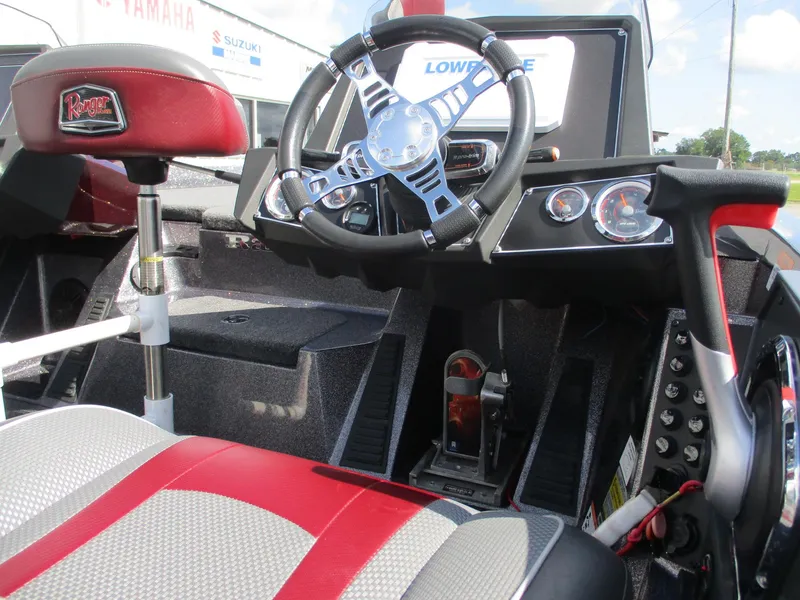 Slide: The Image of 2019 Ranger Z519L boat cockpit with steering wheel and control panel. - 16