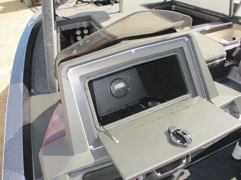 Slide: The Image of 2019 Ranger Z519L boat dashboard with open storage compartment and control panel. - 17