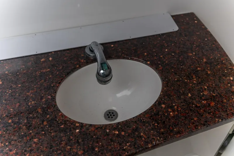 Slide: The Image of Sink with dark speckled countertop in 2015 Edgewater 280 CX boat. - 16