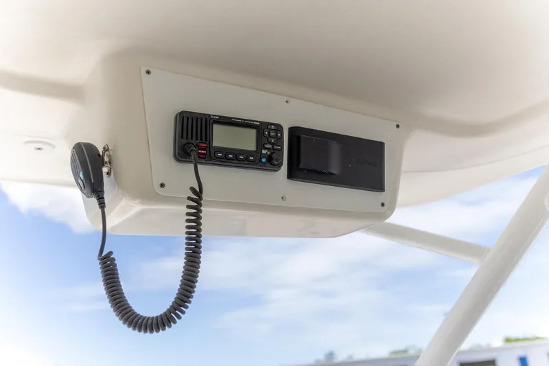 Slide: The Image of Radio and speaker system on 2015 Edgewater 280 CX boat, mounted under a white panel. - 19
