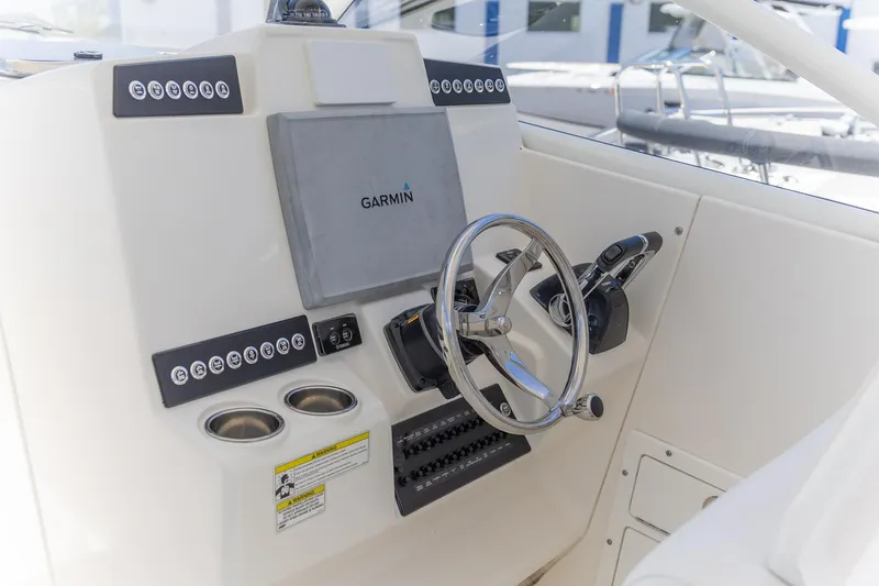 Slide: The Image of Edgewater 280 CX 2015 boat helm with Garmin navigation system and controls. - 3