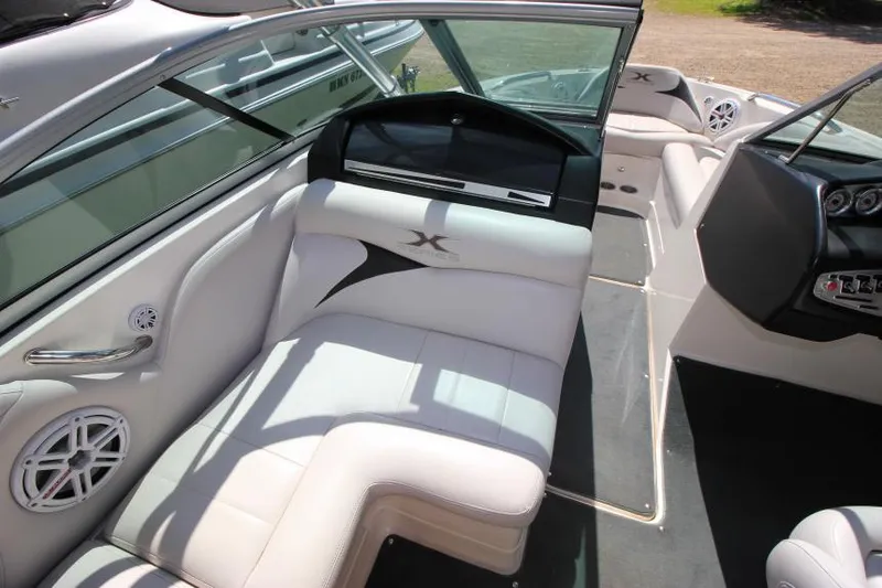 Slide: The Image of 2008 MasterCraft X-15 SS boat interior with white seating and modern dashboard. - 14