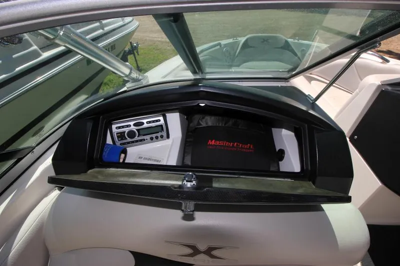 Slide: The Image of 2008 MasterCraft X-15 SS boat dashboard with stereo system and storage compartment. - 15