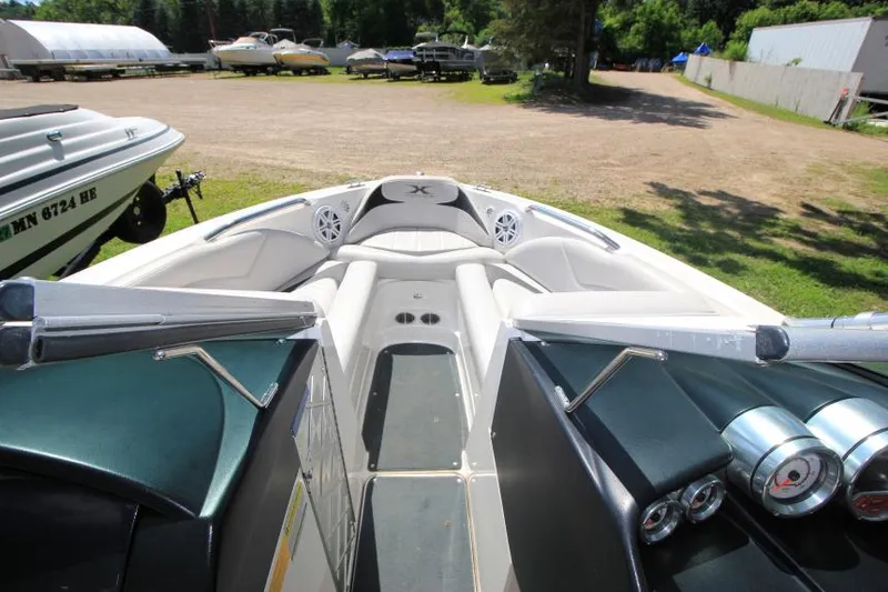 Slide: The Image of 2008 MasterCraft X-15 SS boat interior with seating and dashboard, parked outdoors. - 16