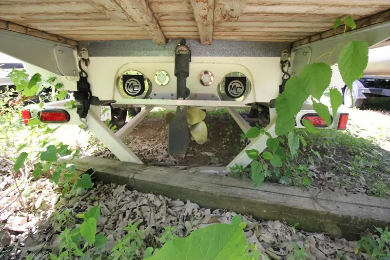 Slide: The Image of 2008 MasterCraft X-15 SS boat underside with propeller and foliage. - 5