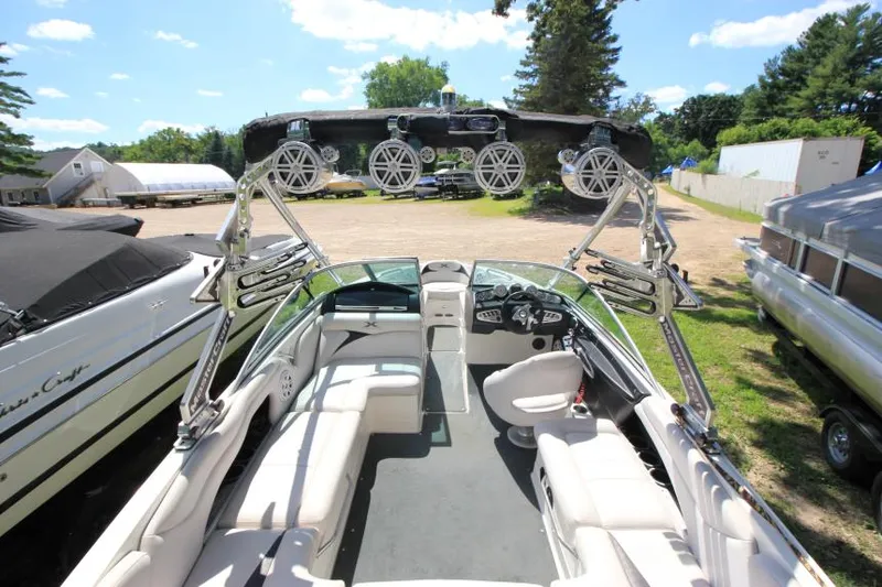 Slide: The Image of 2008 MasterCraft X-15 SS boat interior with seating and wakeboard tower, parked outdoors. - 6
