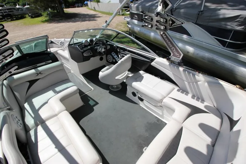 Slide: The Image of 2008 MasterCraft X-15 SS boat interior with white seating and steering console. - 9