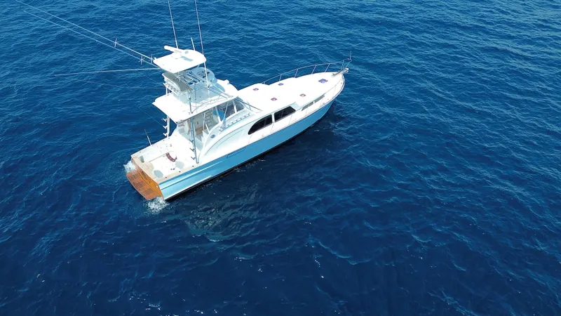 The Image of Aerial view of 2015 Huckins 45 yacht cruising on open blue sea. - 1