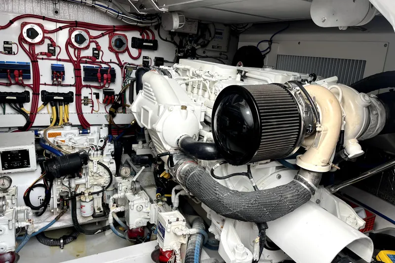 Slide: The Image of Engine room of a 2015 Huckins 45 boat, showcasing complex machinery and wiring. - 15