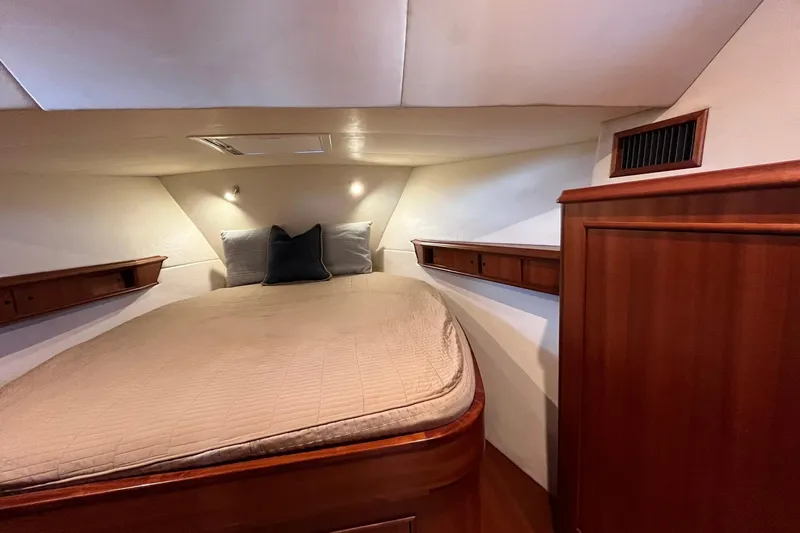 Slide: The Image of Cozy cabin interior of 2015 Huckins 45 yacht with elegant wood finish and comfortable bedding. - 18