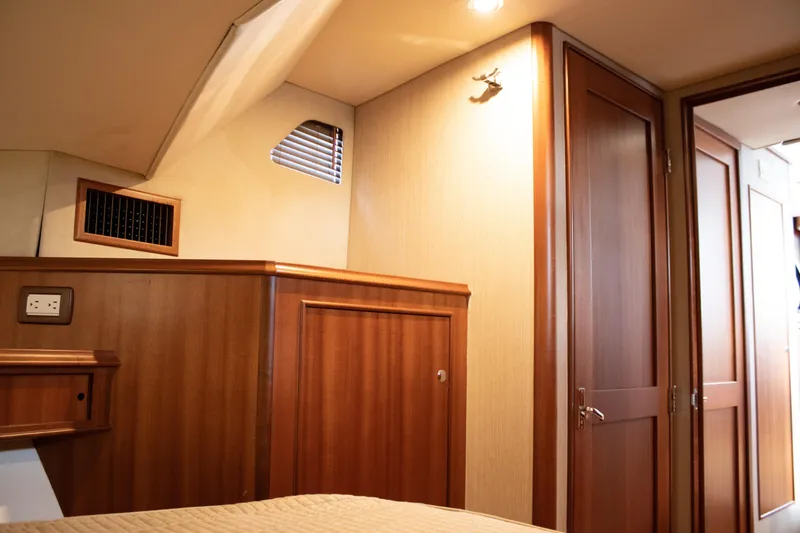 Slide: The Image of Interior cabin of 2015 Huckins 45 yacht with wooden paneling and modern lighting. - 20