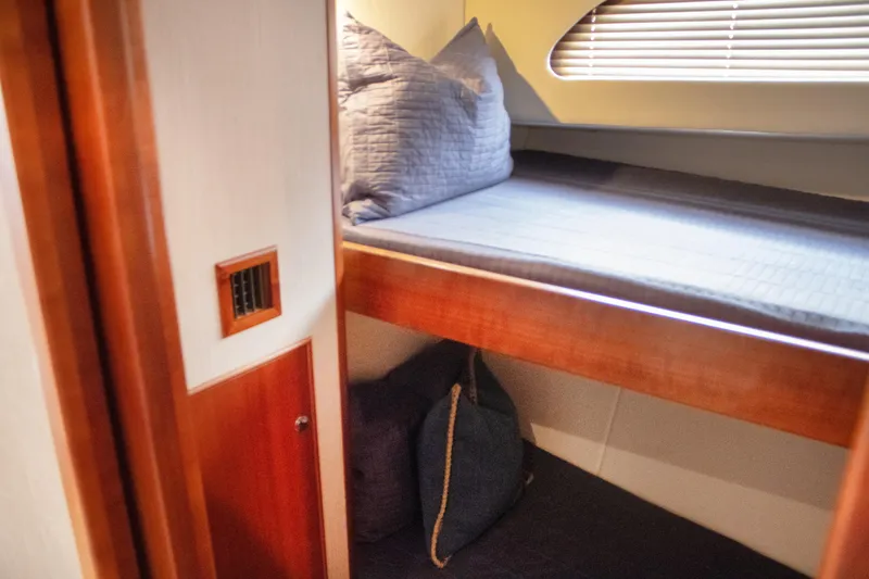 Slide: The Image of Interior of 2015 Huckins 45 yacht with cozy bunk beds and wooden accents. - 22