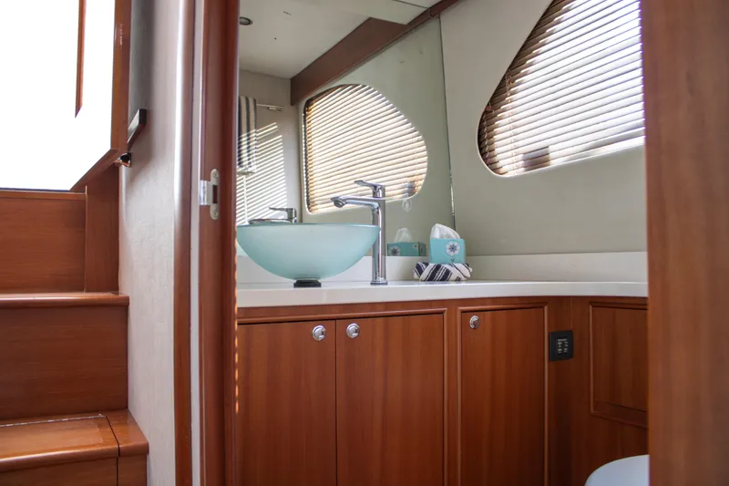 Slide: The Image of Luxurious bathroom interior of 2015 Huckins 45 yacht with wooden cabinetry and modern fixtures. - 25