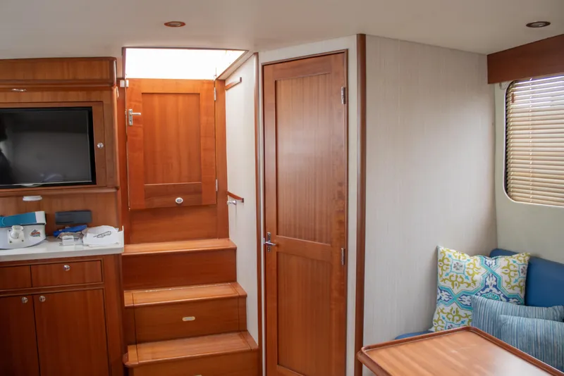 Slide: The Image of Luxurious interior of 2015 Huckins 45 yacht with wooden finishes and cozy seating area. - 26