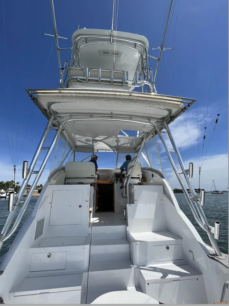 Slide: The Image of 2015 Huckins 45 yacht with upper deck, clear sky, and ocean view. - 7