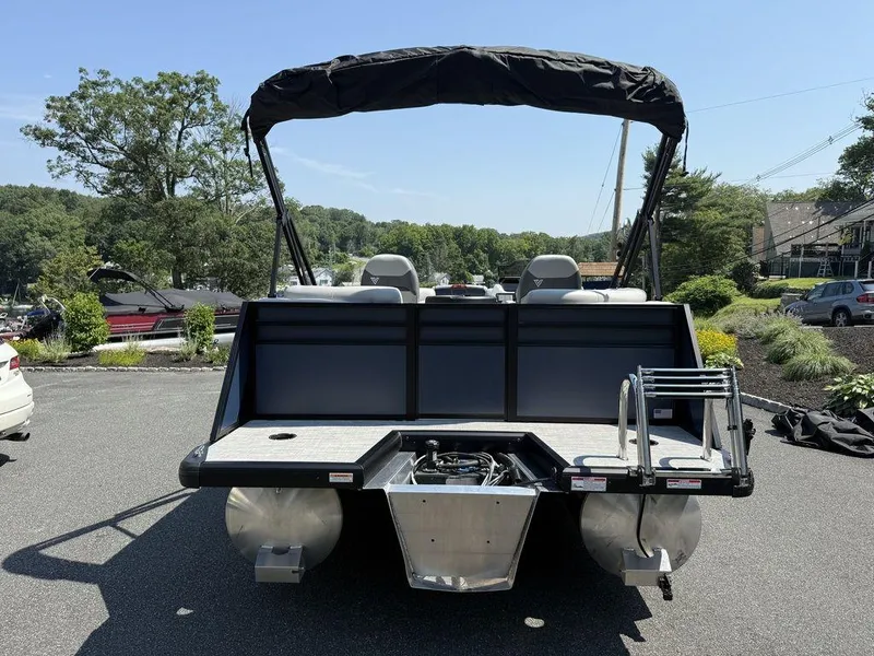 Slide: The Image of 2026 Viaggio V18U pontoon boat with canopy, parked outdoors on a sunny day. - 5