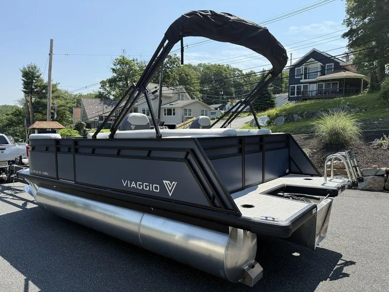 Slide: The Image of 2026 Viaggio V18U pontoon boat parked on a residential street. - 8