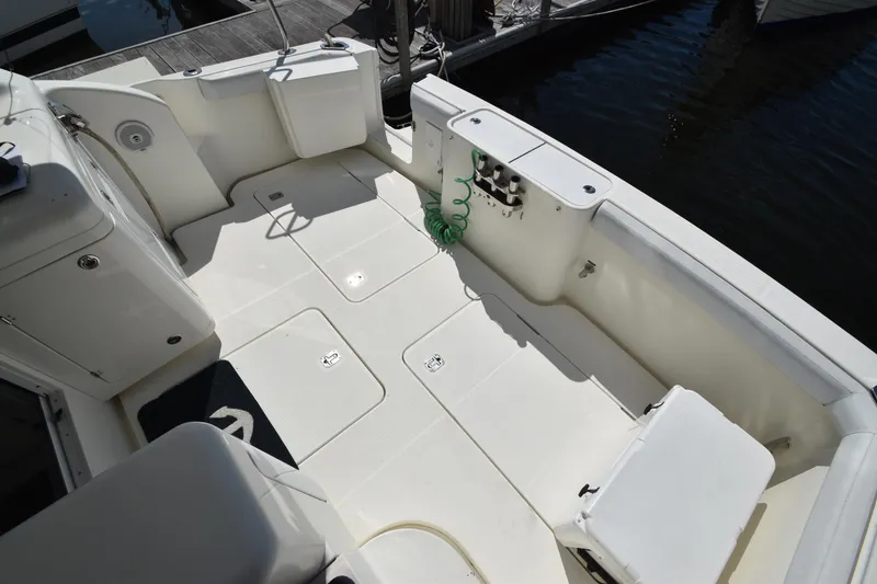 Slide: The Image of Spacious deck of 2007 Silverton 38 Convertible yacht, featuring clean white surfaces and dockside view. - 10