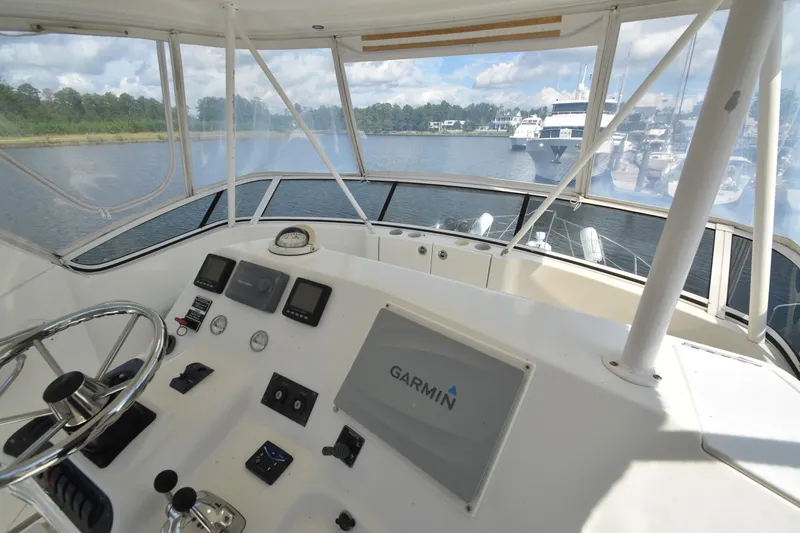 Slide: The Image of 2007 Silverton 38 Convertible yacht helm with Garmin navigation, docked in a marina. - 11
