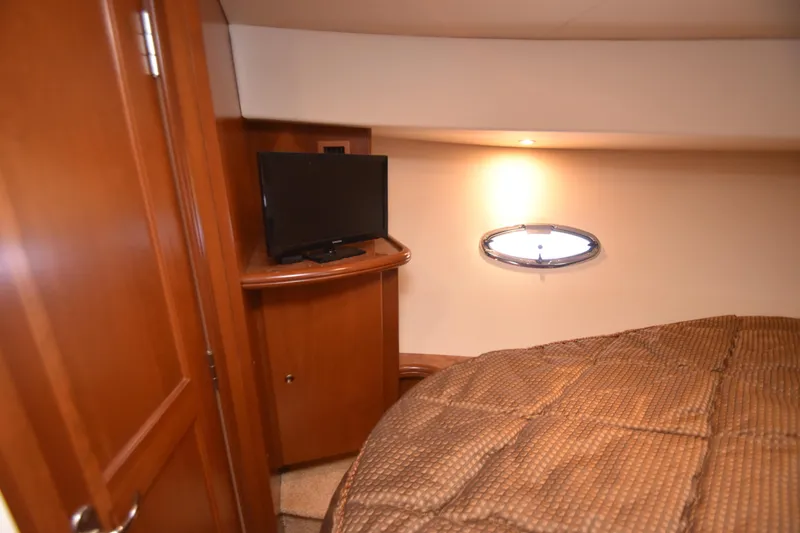 Slide: The Image of Cozy cabin interior of 2007 Silverton 38 Convertible with TV and porthole window. - 19