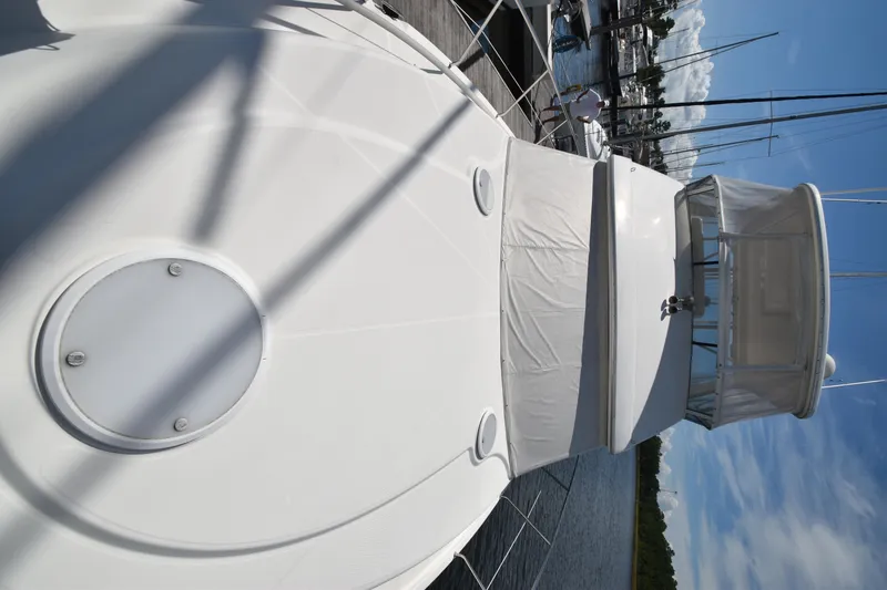 Slide: The Image of 2007 Silverton 38 Convertible yacht docked under clear blue sky. - 2