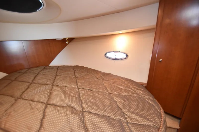 Slide: The Image of 2007 Silverton 38 Convertible cabin interior with bed and wooden cabinetry. - 21