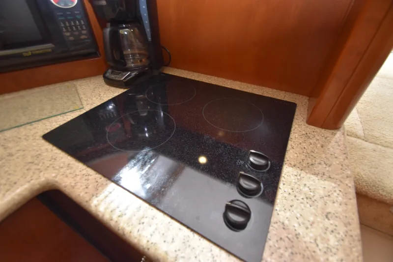 Slide: The Image of 2007 Silverton 38 Convertible yacht kitchen with electric stovetop and coffee maker. - 25