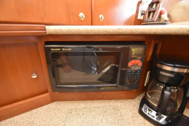 Slide: The Image of Microwave and coffee maker in 2007 Silverton 38 Convertible yacht kitchen. - 26